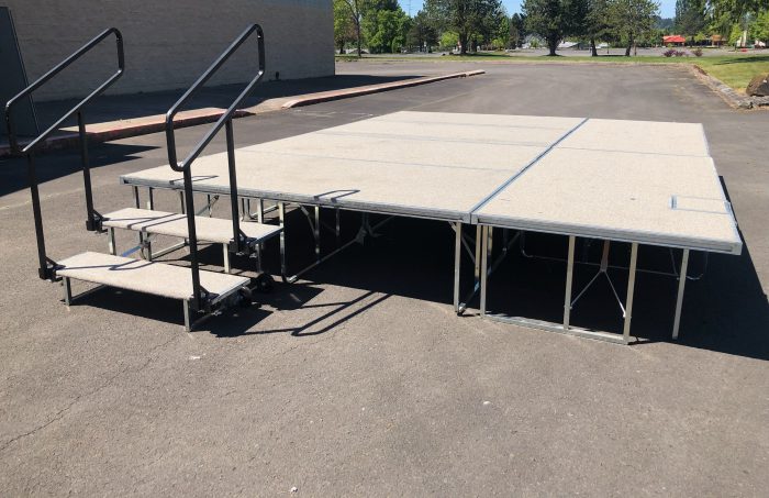 white outdoor carpeted stage with stairs
