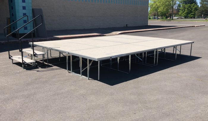 White carpeted stage set up outside