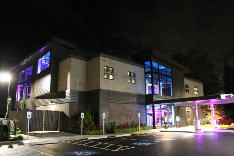 large building with purple entrance lights large building with purple entrance lights