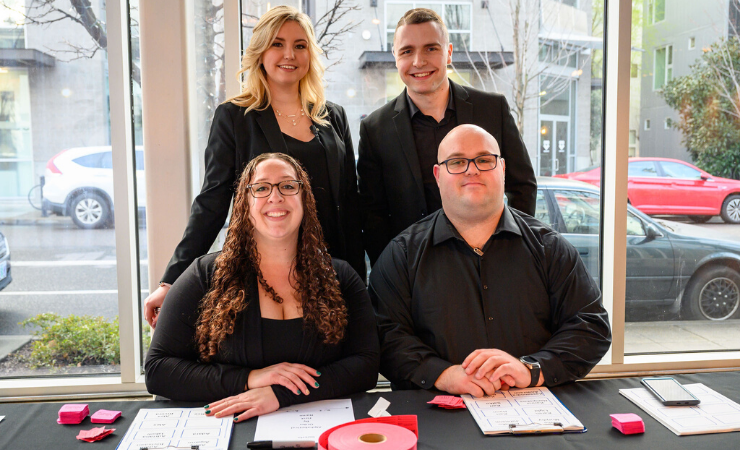 Treadway Events staff posing at welcome table for event Production & Execution