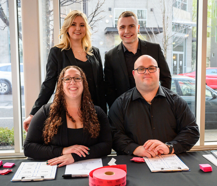 Group of Treadway Events staff at welcome table Group of Treadway Events staff at welcome table