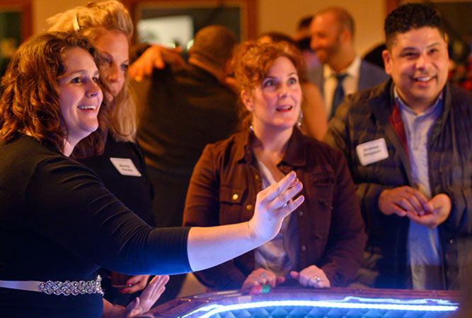 three women playing casino games at event three women playing casino games at event