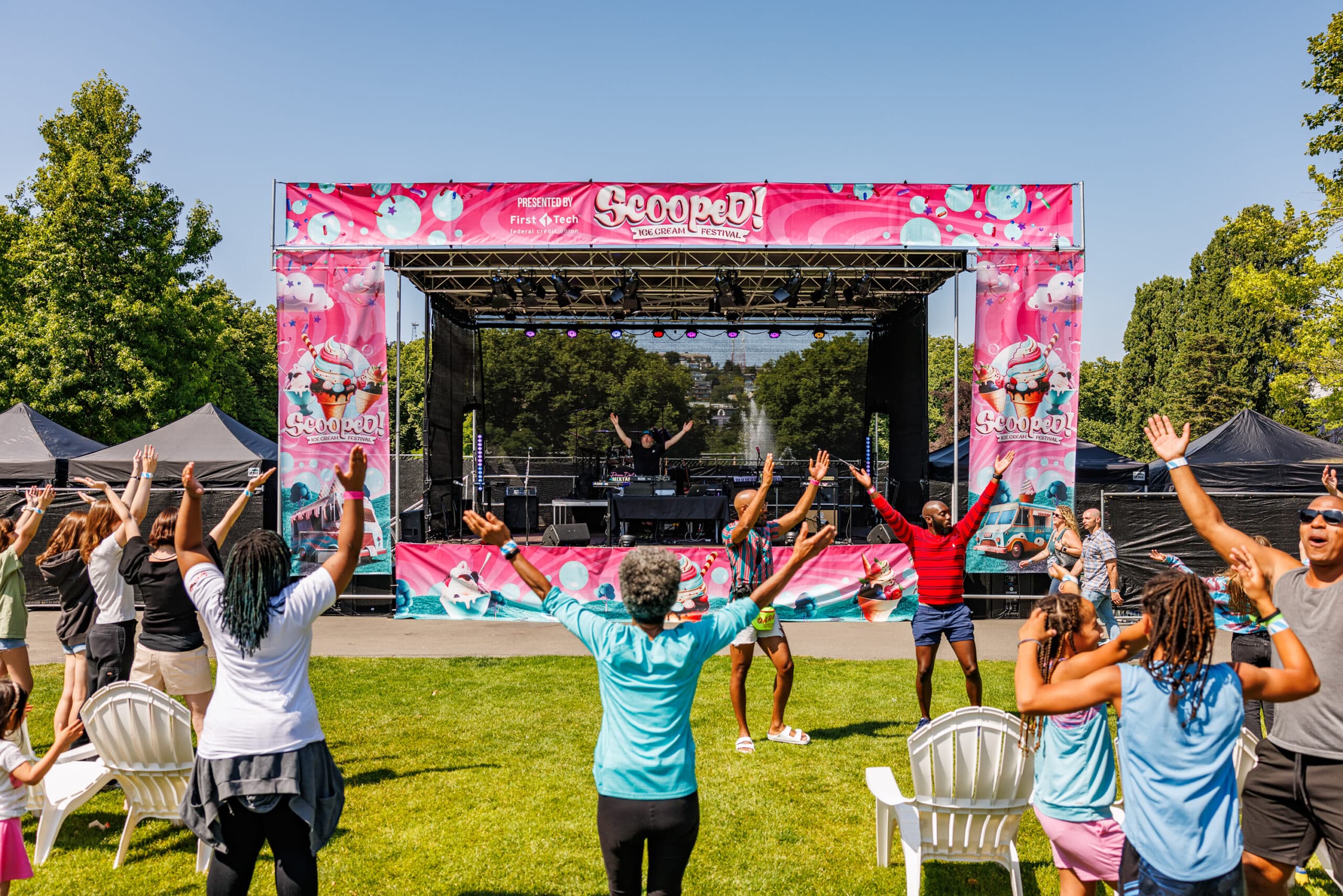 a group of people standing in front of a stage